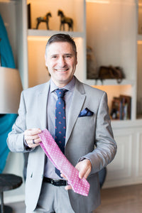 Pasquale Iovinella holding a handmade necktie