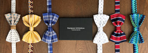 Six bow ties lined up with gift box in the center