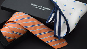 Necktie and pocket square laying on a gift box