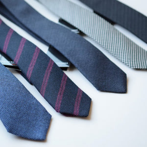 Five wool neckties laying a on table